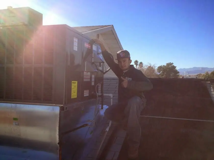 HVAC technician performing HVAC Inspection on a rooftop unit in Fairwood